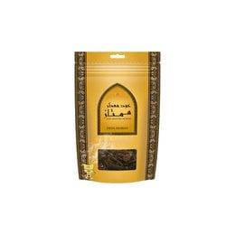 "Golden yellow bakhoor incense pouch, dark wood chips, Arabic text, traditional aromatic incense blend"