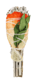 A cylindrical sage torch with a citrine crystal, approximately 10 cm in length, surrounded by green leaves.