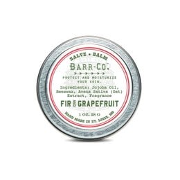 Fir and grapefruit scented hand salve in a round tin container.