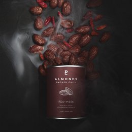 Smoked almonds with chili seasoning, in a dark red container with a label that says "Almonds - Chili Smoke - Mini 60g".
