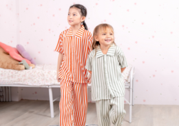 Striped kids' pajamas in various colors including pink, brown, yellow, black, blue, green, and orange. The pajamas feature a relaxed, comfortable fit and are suitable for children aged 1-7 years.