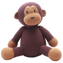 A dark brown crocheted monkey plush toy with a friendly expression.