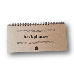 A spiral-bound desk planner with a neutral-colored cover and lined pages for organizing daily tasks and schedules.