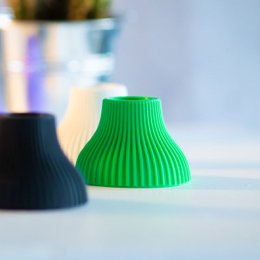 Colorful candle holders in various shapes and sizes, including round, tall, and fluted designs. The holders come in a range of vibrant colors such as green, orange, yellow, and purple.