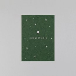 Green Christmas card with white stars, made of wood pulp material.