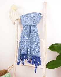 Blue and light blue Turkish hammam towel with tasseled edges, made of soft, absorbent cotton material. Suitable for use as a beach towel, spa towel, or sauna towel.