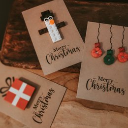 A set of 3 Lego-themed Christmas cards featuring a penguin character, holiday text, and ornament decorations.