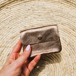  Compact bronze-colored wallet with snap closure, suitable for carrying essentials.