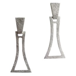 Unique silver-toned statement earrings with an abstract, geometric design. The earrings feature a distinctive triangular shape with a textured, brushed metal finish.