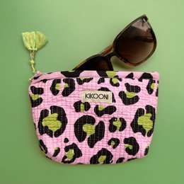 A small, handmade makeup pouch in a vibrant pink color with a bold leopard print pattern. The pouch features a tassel zipper pull and is perfect for storing cosmetics, jewelry, or other small items.