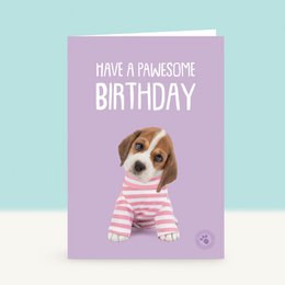  A birthday card featuring a cute beagle puppy wearing a striped shirt and holding balloons. The card has the text "Have a pawsome birthday" written on it.