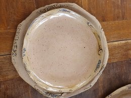 Flat, round dinner plate made of stoneware with a creamy white, matte finish. Handcrafted, unique design.