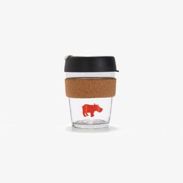 Reusable glass coffee cup with a red buffalo logo and cork sleeve. Features a black lid and silicone grip.