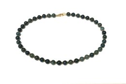  Green aventurine beaded necklace with round, smooth beads in a natural green color.