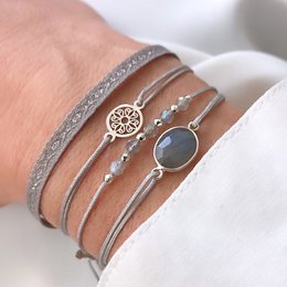 Elegant bracelet set in rose gold, silver, and gold tones featuring a floral charm and beaded accents.