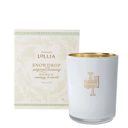 A round, tall white candle with a floral pattern on the packaging. The candle is scented and part of the LOLLIA Breathe Luminary collection.