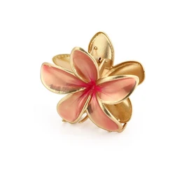  A pink and gold flower-shaped hair clip with a decorative design.