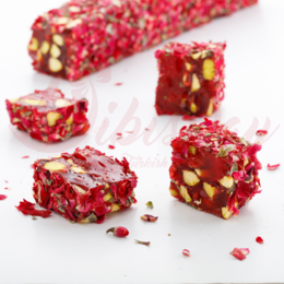 Red gummy candies with rose petals, nuts, and a wooden bowl.