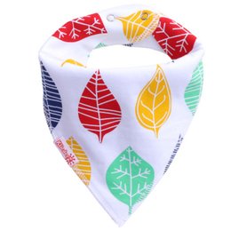Colorful leaf-patterned baby bib with a pointed shape.
