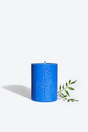 Tall, round, blue candle with geometric pattern. Scented candle in Nordic style.