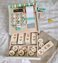 Wooden play money set with various denominations and symbols, including euro currency symbols and numbers.