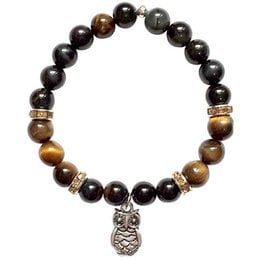 This bracelet features a mix of tiger eye and black beads, with a decorative owl charm. The bracelet has a natural, earthy style with a touch of whimsy.