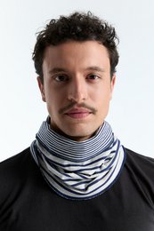  A reversible loop scarf in a navy blue and beige striped pattern. The scarf is unisex and can be worn in multiple ways.