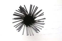 Black bent drinking straws in a 50-pack. Durable plastic straws with a unique curved design for a fun drinking experience.