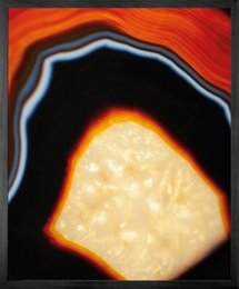 Framed printed canvas wall art featuring a vibrant geode design with orange, black, and white colors. The abstract, natural pattern creates a striking visual impact.