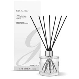 A white and glass reed diffuser bottle with black reeds. The product is labeled "White Nectarine & Pear Diffuser 200ml" and is categorized as a "Reed Diffuser".
