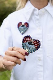 Pair of evil eye heart brooches, colorful beaded hearts, cream and blue plush slippers