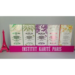 Two pink plastic rulers displayed on a pink stand with the text "Institut Karte Paris" printed on it. The rulers appear to be decorative or display items rather than functional measuring tools.