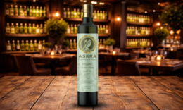  Organic extra virgin olive oil in a glass bottle with a rustic wooden background.