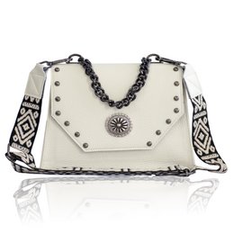 Cream leather shoulder bag with black and white patterned strap, silver-tone hardware, and decorative metal embellishment.