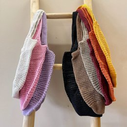  Crocheted white shoulder bag with a knotted handle, suitable for casual or formal occasions.