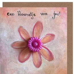 A colorful handmade card with a vibrant flower and the text "Een bloemetje voor jou!" which translates to "A little flower for you!" in English. The card appears to be a greeting or thank you card.