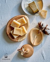 Rectangular amber-colored perfume block with a light green tint, made of natural ingredients.