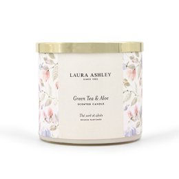A tall, round green tea and aloe scented candle in a glass jar with a gold lid, surrounded by green leaves and white flowers.
The product is a Laura Ashley Green Tea & Aloe scented candle, weighing 400g. The candle is housed in a glass jar with a gold-colored lid. The candle has a green tea and aloe fragrance, as indicated by the product title and description. The image shows the candle surrounded by green leaves and white flowers, suggesting a natural, botanical theme.