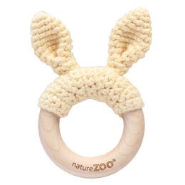Creamy white wooden teether with bunny ears, designed for babies to safely chew on and soothe gums during teething.