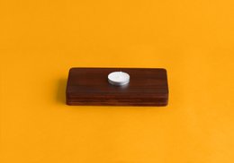 Rectangular wooden storage basket with a single white knob on the front, made of walnut wood.