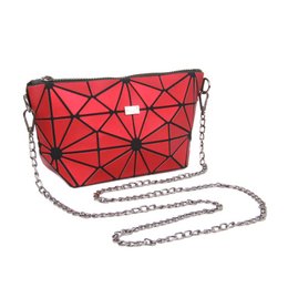 A small, geometric red and black handbag with a chain strap. The bag features a unique triangular pattern design and a compact, clutch-like silhouette.