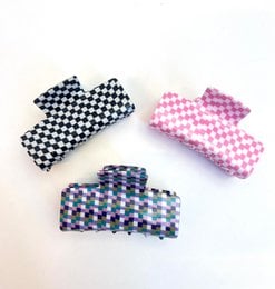 Black, pink, and multicolored checkered hair clips in various shapes and sizes.