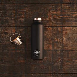 A sleek, black thermos bottle with a minimalist design and a metallic cap.