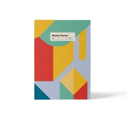 A colorful, geometric weekly planner with a totem design. The planner features a vibrant pattern of shapes and colors, including circles, triangles, and stripes in shades of red, blue, yellow, and black.