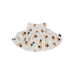 A white summer skirt with a peach and orange print pattern, suitable for children aged 6-14 years old. The skirt has a flared, A-line silhouette and is made of a lightweight, breathable fabric.