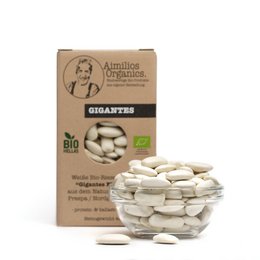Organic dried white giant beans, also known as gigantes, packaged in a cardboard box. The beans have a large, oval shape and a pale white color.