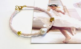A delicate bracelet featuring star, heart, and pearl charms, designed for kids' collections.