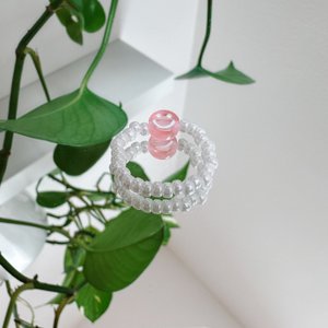 Pearl ring made of white glass beads with a pink smiley