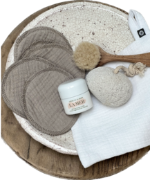 A set of 10 soft, reusable muslin makeup removal pads in a variety of neutral colors including gray, white, blue, pink, and beige.