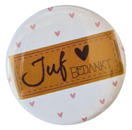 A round mirror with a silver frame and a text that says "Juf bedankt" (Teacher, thank you) in a handwritten style. The mirror has a white background with small pink heart shapes.